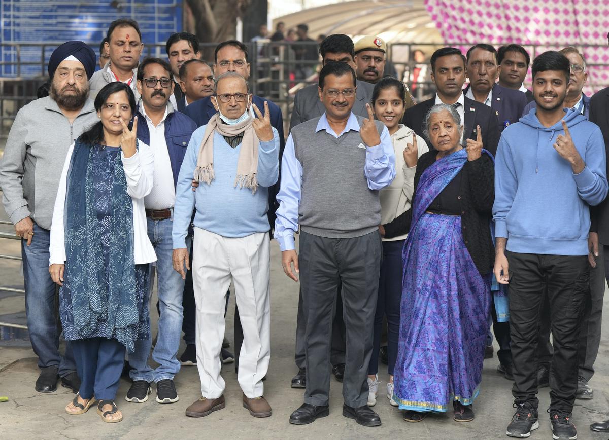 Delhi Chief Minister Arvind Kejriwal and his family members show their fingers marked with indelible ink after casting their votes for the MCD elections, at a polling station in Civil Lines area on December 4, 2022.