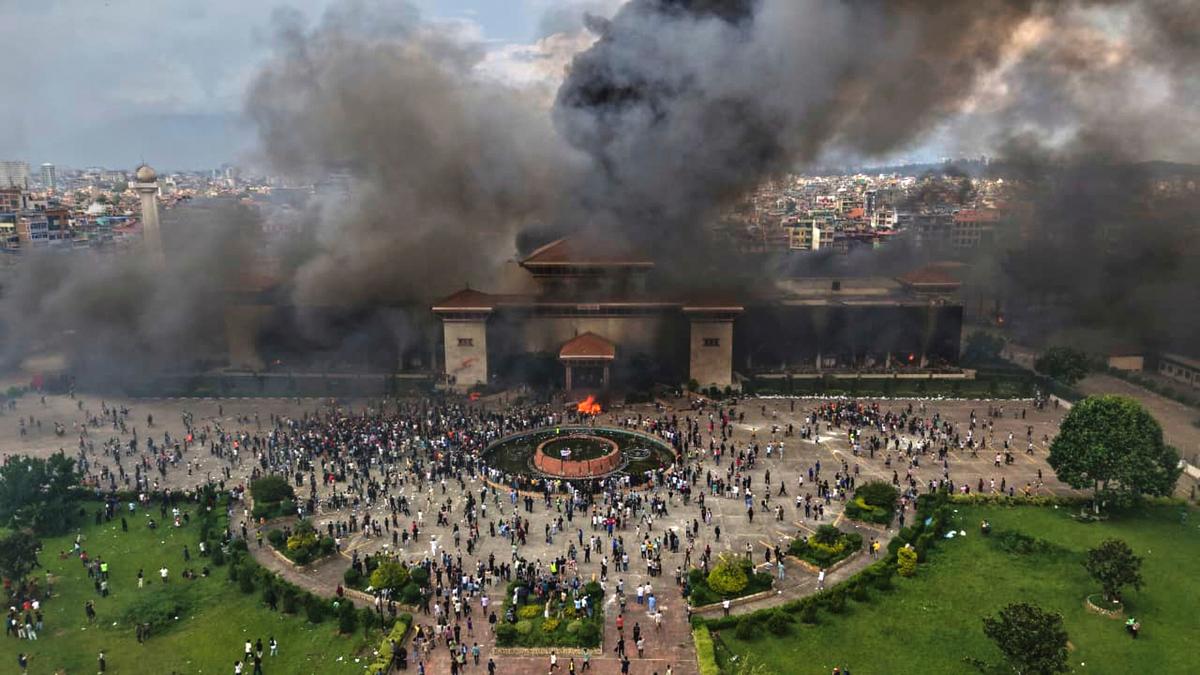 Protesters celebrate at the Singha Durbar, the seat of Nepal’s government’s various ministries and offices after it was set on fire during a protest on September 9, 2025. Protesters celebrate at the Singha Durbar, the seat of Nepal’s government’s various ministries and offices after it was set on fire during a protest on September 9, 2025.