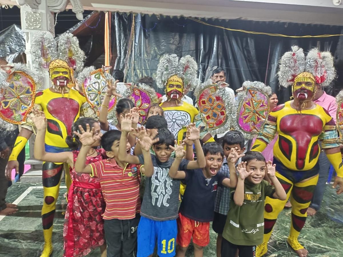 Children with Puli veshalu artistes in Vasant Vihar Regency in Vizianagaram. Ganesh pandal organising committee Challa Sugunakara Rao said such dance performances will help the youth learn the heritage, culture and traditions of Vizianagaram.