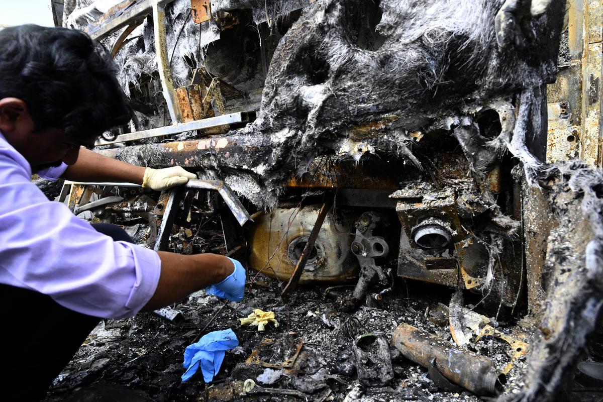Forensic personnel and police investigate the accident site. Forensic personnel and police investigate the accident site.