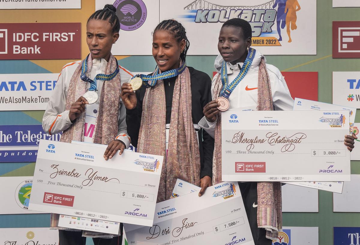 Champion Desi Jisa, centre, with runner-up Zeineba Yimer, left, and Mercyline Chelangat.