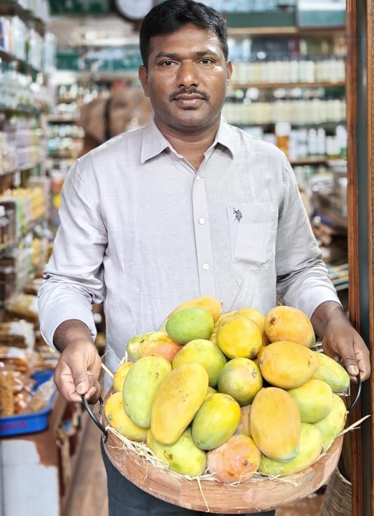 B Gangadhara Murthy  of Grameena Angadi with the fresh organic mangoes