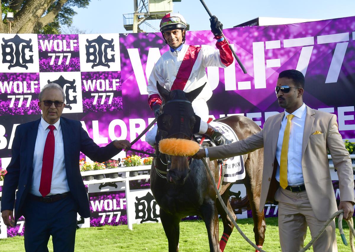 Victoria Punch (jockey P Trevor up) winner of The Wolf 777 Bangalore 1000 Guineas led by owner C. Ananda, right, and trainer Irfan Ghatala, left, at Bangalore Turf Club (BTC), in Bengaluru on December 16, 2022.
