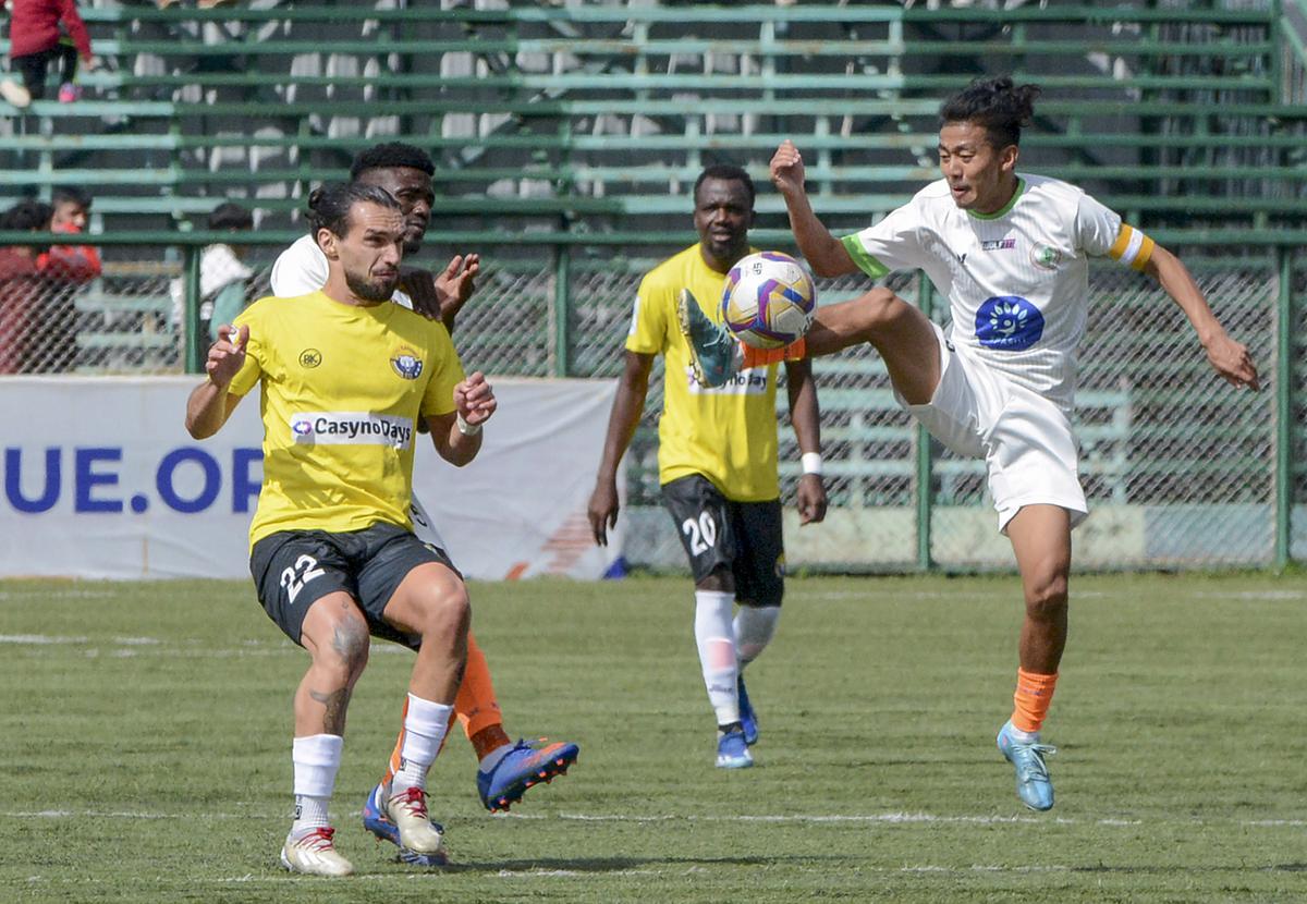 Players of Real Kashmir FC (in yellow) and NEROCA FC vie for the ball during their I-League 2023-24 football match, in Srinagar, on March 30, 2024.