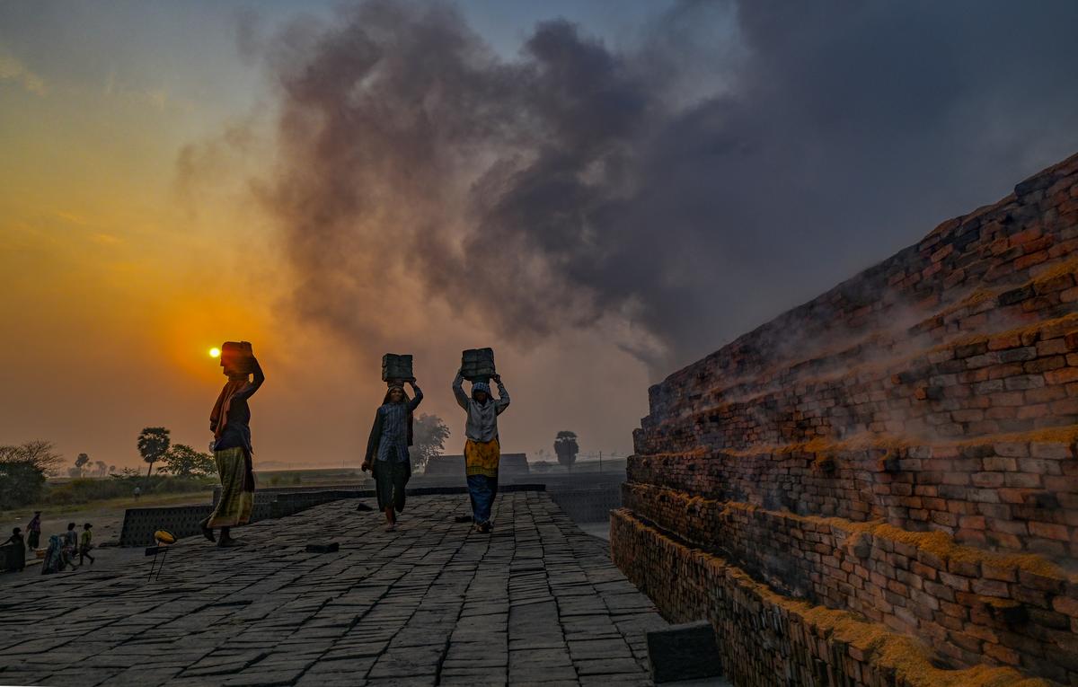  Women begin work at sunrise at a brick kiln near Visakhapatnam.