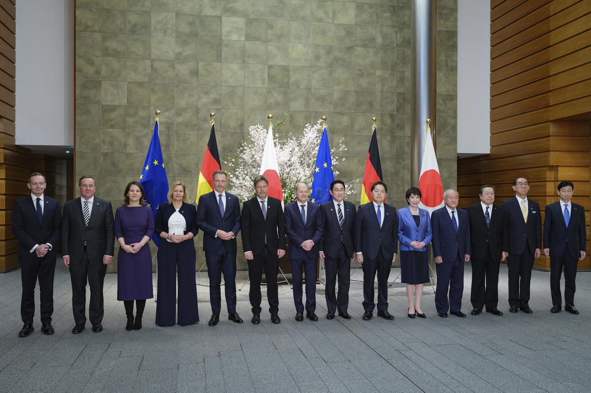 German Chancellor Olaf Scholz, center left, and Japan’s Prime Minister Fumio Kishida, center right, pose for a family pictures at prime minister’s official residence in Tokyo Saturday, March 18, 2023. 
