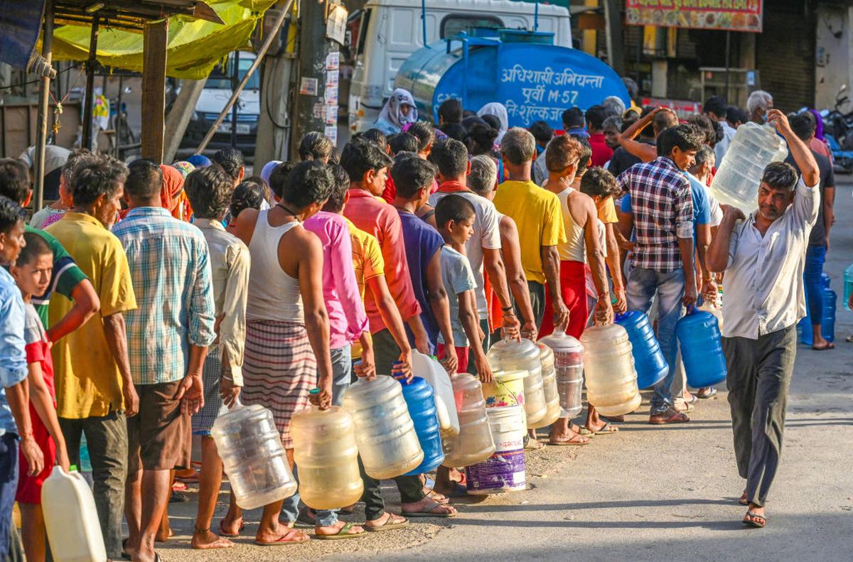 People queue up for water during a heatwave in Delhi last June.