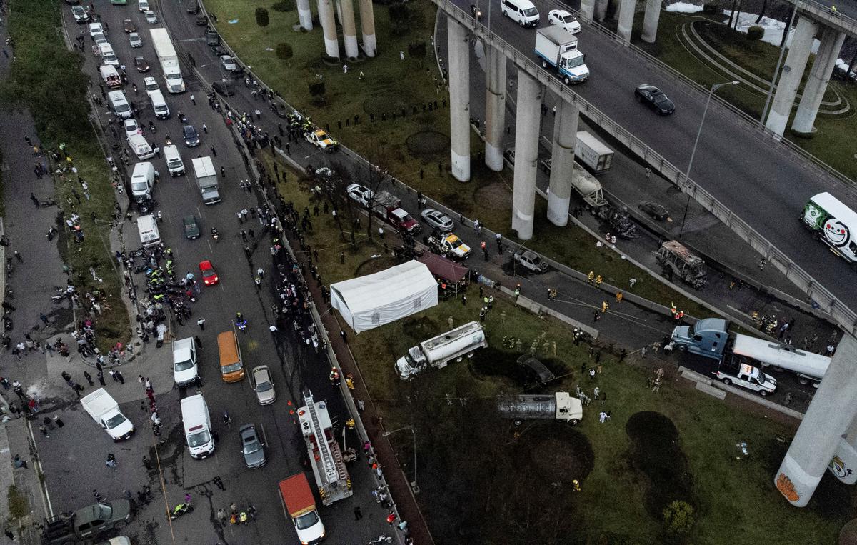 A drone view shows emergency personnel working at the site of a gas tanker explosion on Ignacio Zaragoza Avenue, where multiple individuals sustained burn injuries after the vehicle overturned, in Mexico City, on September 10, 2025.