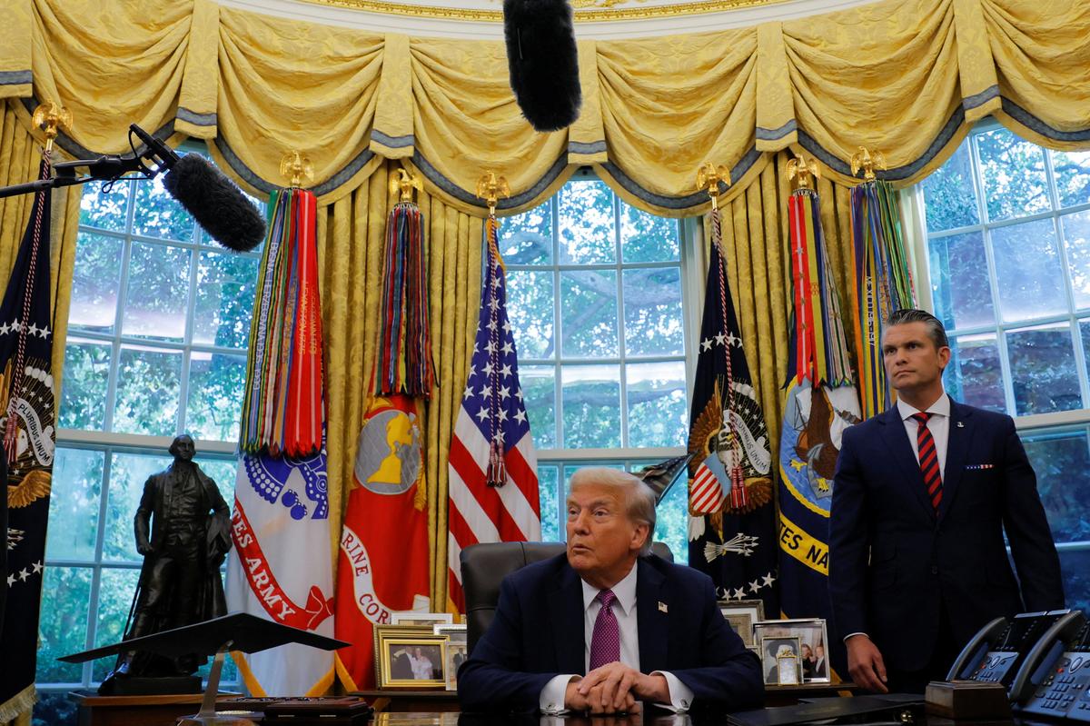 U.S. President Donald Trump speaks with the media on the day of the signing of an executive order to rename the Department of Defence the “Department of War”, accompanied by U.S. Defence Secretary Pete Hegseth, in the Oval Office, at the White House.