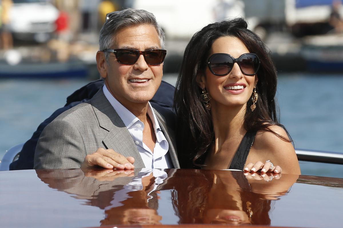 George Clooney, left, and Amal Alamuddin arrive in Venice, Italy, on Sept. 26, 2014, for their upcoming wedding George Clooney, left, and Amal Alamuddin arrive in Venice, Italy, on Sept. 26, 2014, for their upcoming wedding