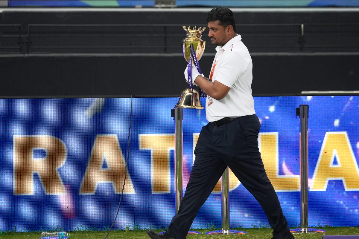 An official removes the winners’ trophy from the presentation area after India won the Asia Cup cricket final against Pakistan at Dubai International Cricket Stadium, on September 28, 2025.
