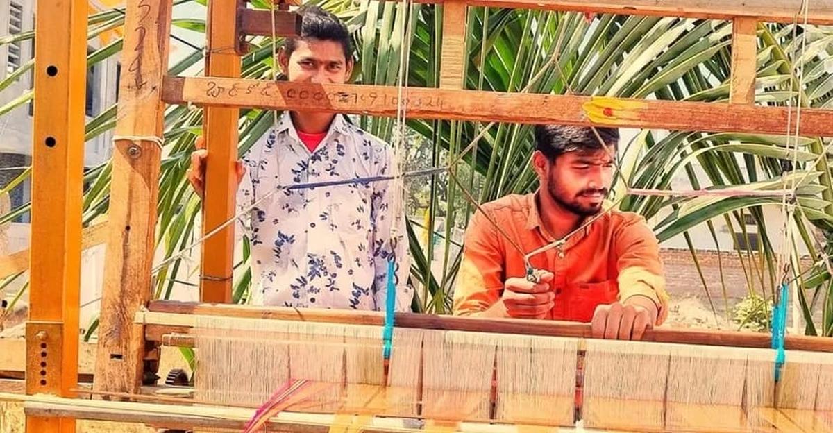 Pavan (right) at his loom Pavan (right) at his loom