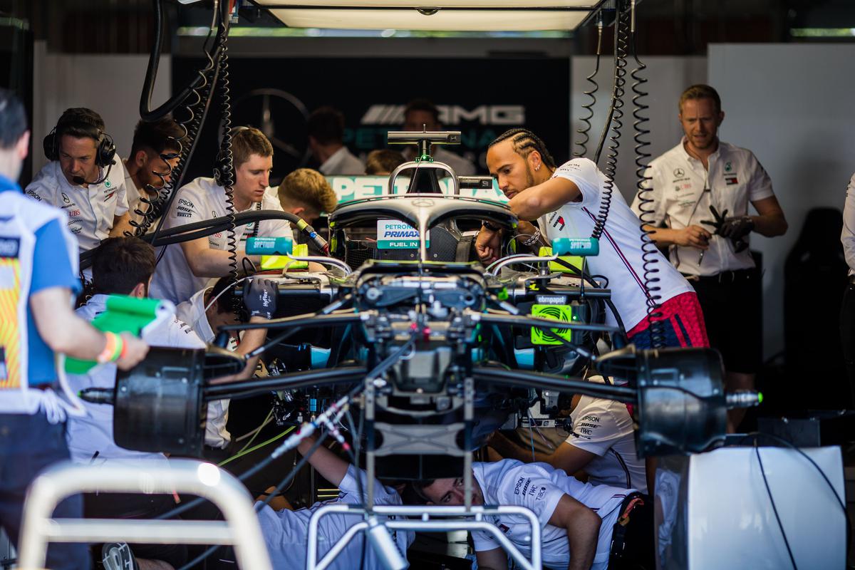 Lewis Hamilton inspects his car surrounded by mechanics during the 2019 Canadian Grand Prix.