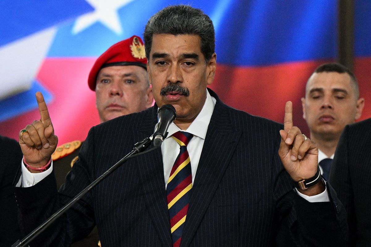 Venezuela’s President Nicolas Maduro addresses the media next to his wife Cilia Flores after appearing before the Supreme Court of Justice in Caracas on August 9, 2024. 