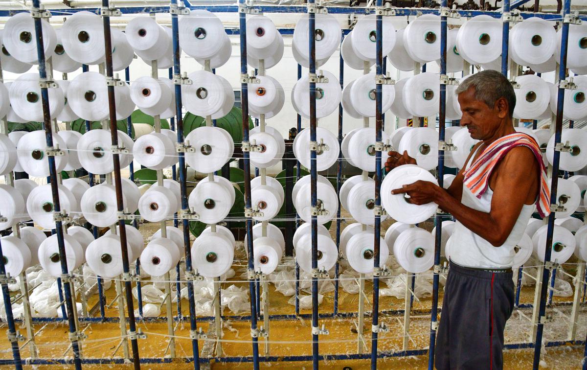 A worker processing yarn at a sizing unit in Erode district, Tamil Nadu
