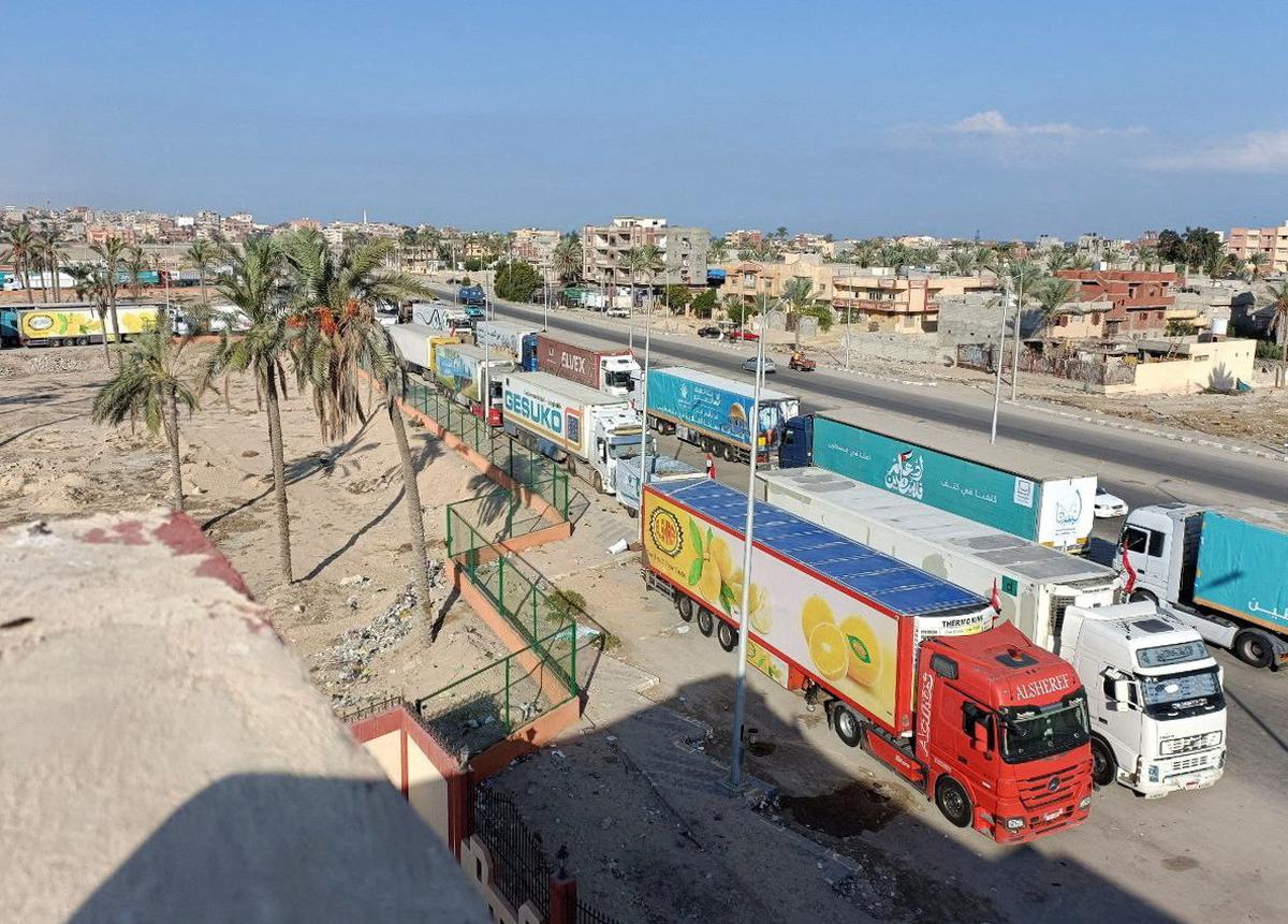 Trucks carrying humanitarian aid for Palestinians wait for the re-opening of the Rafah border crossing to enter Gazas, in the city of Al-Arish, Sinai peninsula, Egypt, October 16, 2023. 
