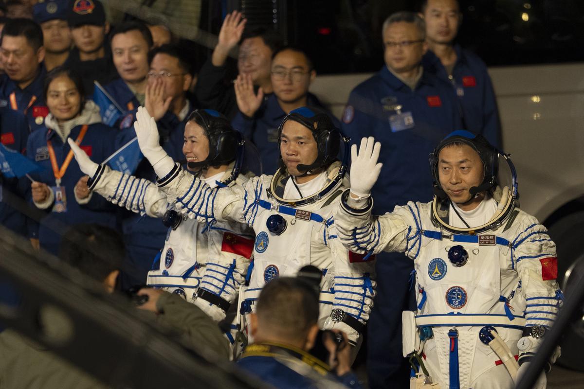 Chinese astronauts Wang Haoze, from left, Song Lingdong and Cai Xuzhe wave during the see-off ceremony for the Shenzhou-19 mission at the Jiuquan Satellite Launch Center in northwestern China, in the early hours of Wednesday (October 30, 2024).