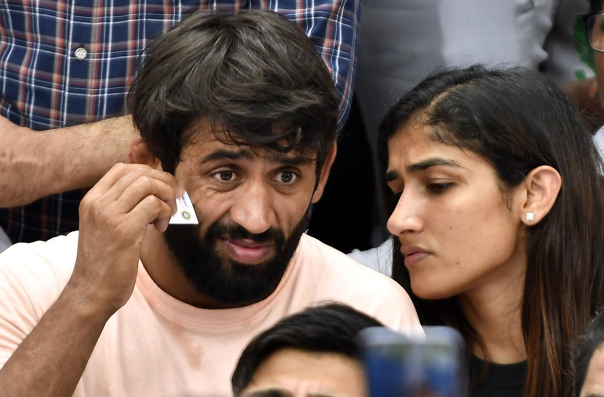 Wrestlers Bajrang Punia and Sangeeta Phogat during their protest against the Wrestling Federation of India Chief Brijbhushan Sharan Singh at Jantar Mantar in New Delhi on Friday, April 28, 2023.