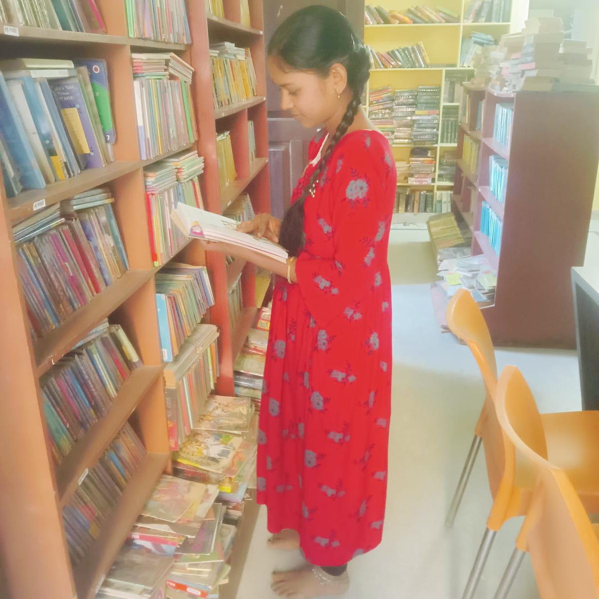 A girl browses books at Just Books A girl browses books at Just Books