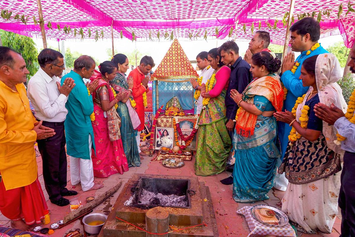 Residents pray for the safe return of stranded NASA astronaut Sunita “Suni” Williams, at a temple in her ancestral village of Jhulasan, about 50 kms from Ahmedabad on March 18, 2025. NASA duo Williams and Barry “Butch” Wilmore stranded in space for more than nine months were finally headed home on March 18, after their capsule undocked from the International Space Station. 