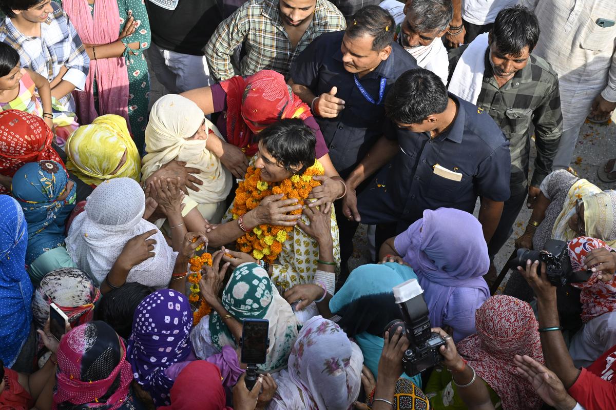 Wrestler-turned-politician and Congress candidate from Julana Assembly constituency Vinesh Phogat being welcomed by women during her election campaign at Assan Village in Jind district of Haryana.