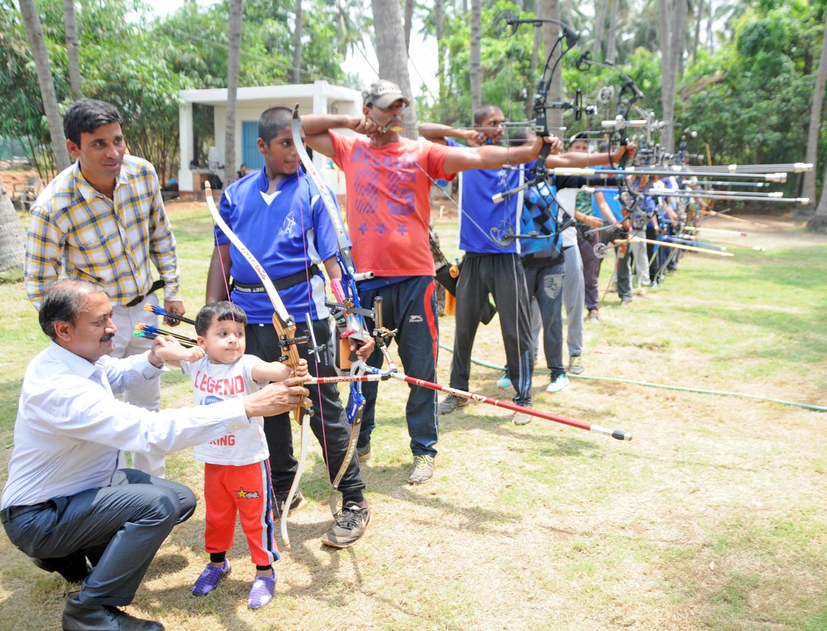 Nature and nurture: Dronacharya awardee Sanjeeva Singh (left) believes the compound bow ‘suits Indians’ because it works well in the hands of ‘people with shorter height’. He prescribes a development programme with scientific support for consistent Olympic success. | Photo credit: T. Singaravelou Nature and nurture: Dronacharya awardee Sanjeeva Singh (left) believes the compound bow ‘suits Indians’ because it works well in the hands of ‘people with shorter height’. He prescribes a development programme with scientific support for consistent Olympic success. | Photo credit: T. Singaravelou