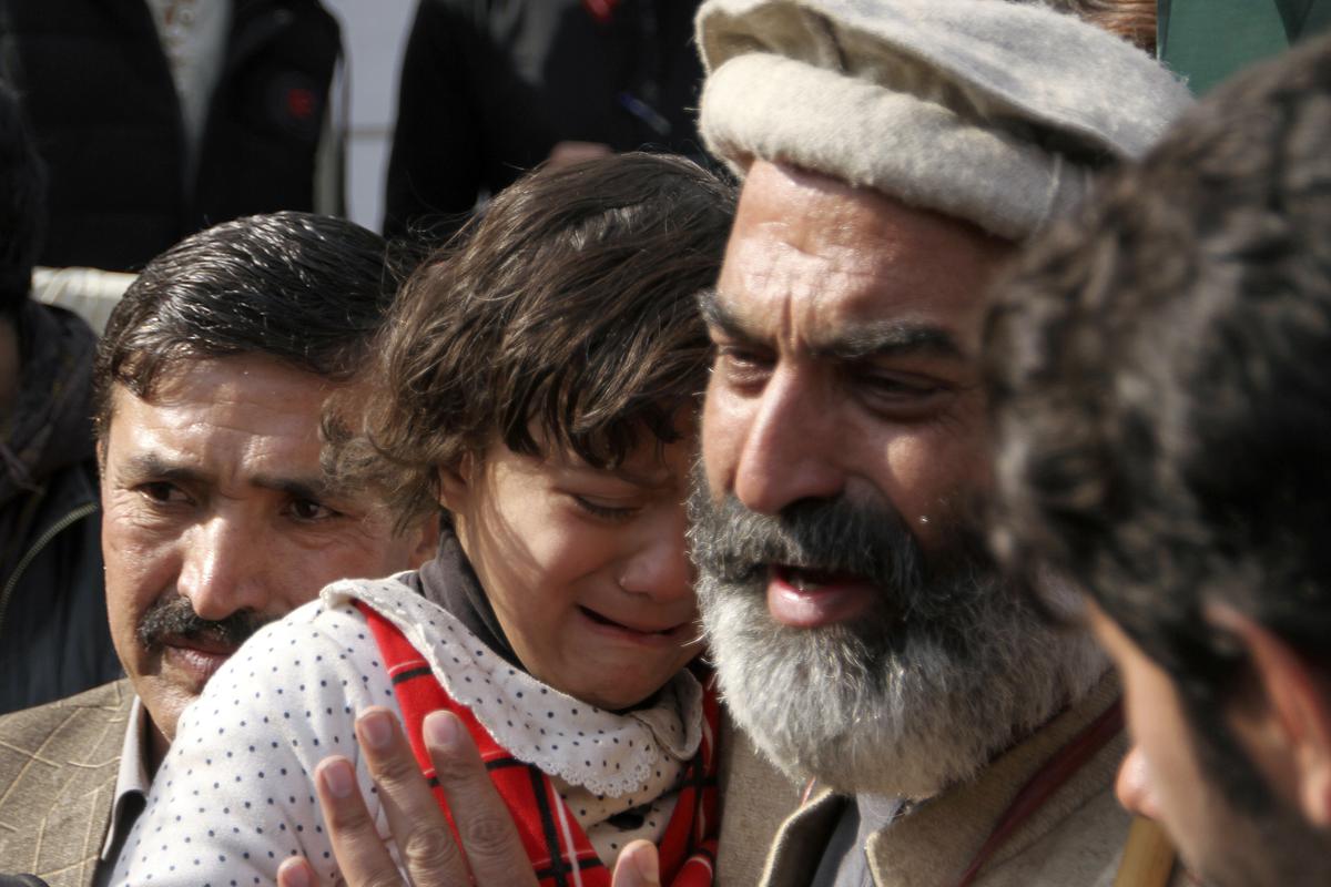 Family members of the victims of Monday’s suicide bombing weep as they take part in a march denouncing militant attacks and demanding peace in the country in Peshawar, Pakistan, on Feb. 1, 2023.