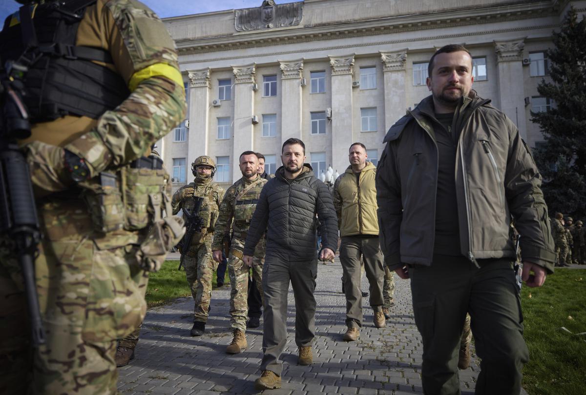 Surrounded by his guards, Ukrainian President Volodymyr Zelenskyy walks on central square during his visit to Kherson, Ukraine on November 14, 2022.