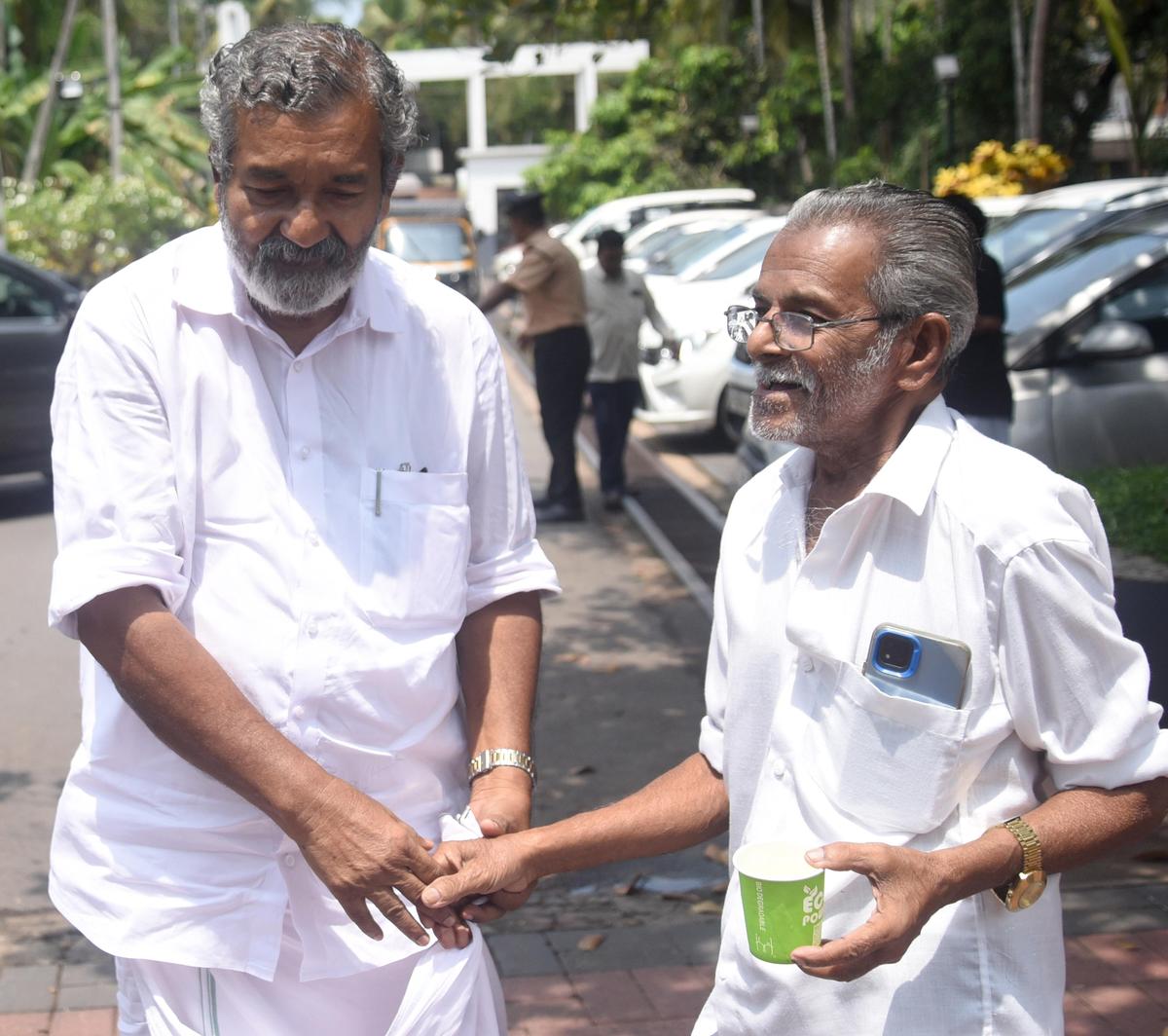LDF candidate M.K. Bhaskaran with a voter at an auditorium in Vallikkad.
