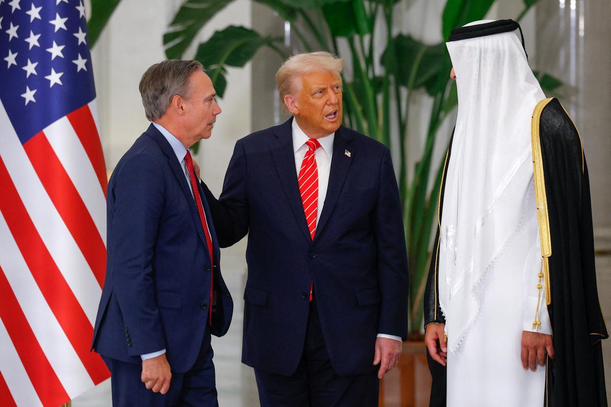 U.S. President Donald Trump speaks with Boeing CEO Kelly Ortberg and Qatar’s Emir Tamim bin Hamad Al Thani ahead of a state dinner at Lusail Palace in Lusail, Qatar, on May 14, 2025.