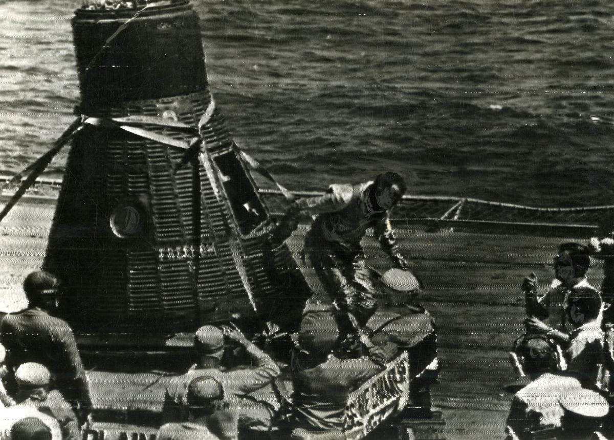 Alan Shepard holds a space helmet as he exits his capsule aboard the aircraft carrier USS Lake Champlain, May 5, 1961.