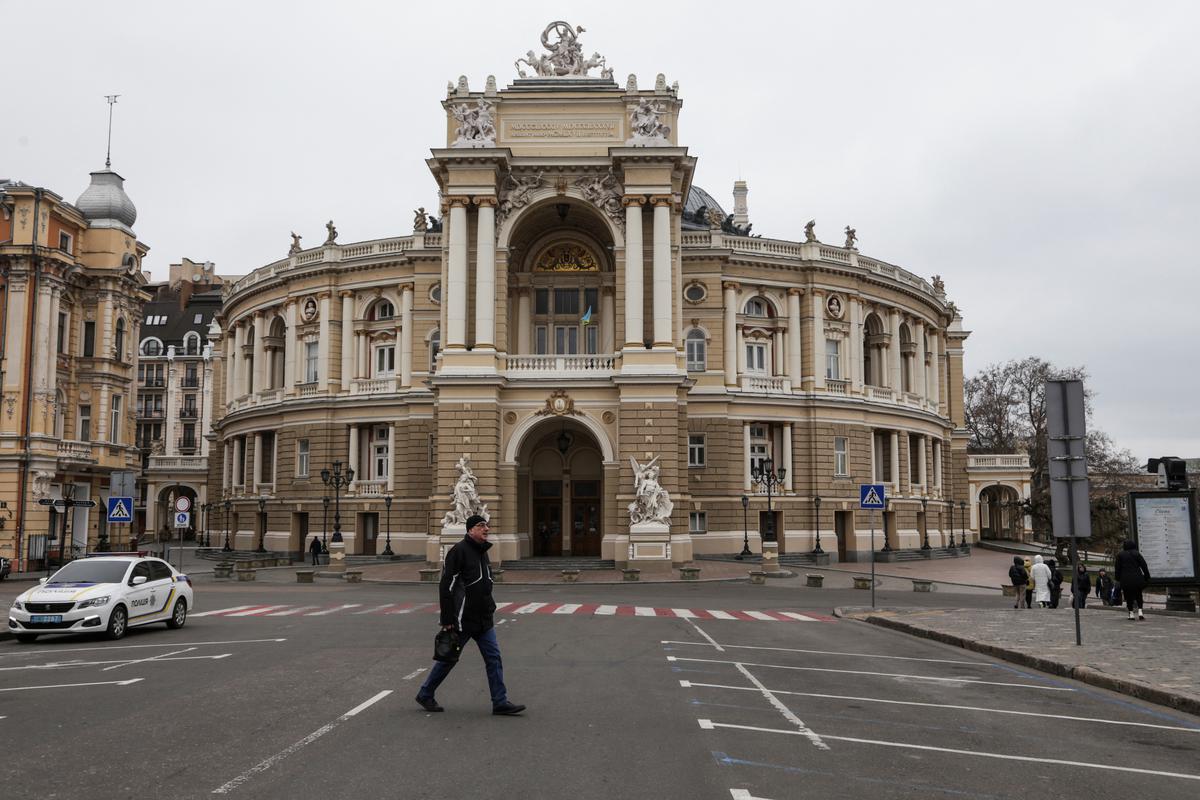A man walks next to the Opera Theatre building in the city centre, amid Russia’s attack on Ukraine, in Odesa.