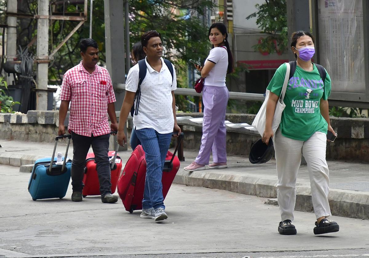 Travellers trying to find autos and cabs during the transport strike in Bengaluru on Monday.