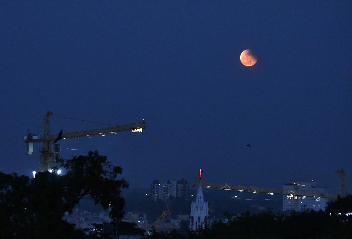Lunar eclipse seen at Shivajinagar in Bengaluru.  A lunar eclipse occurs when the moon passes through the shadow region of the earth on a full moon night.