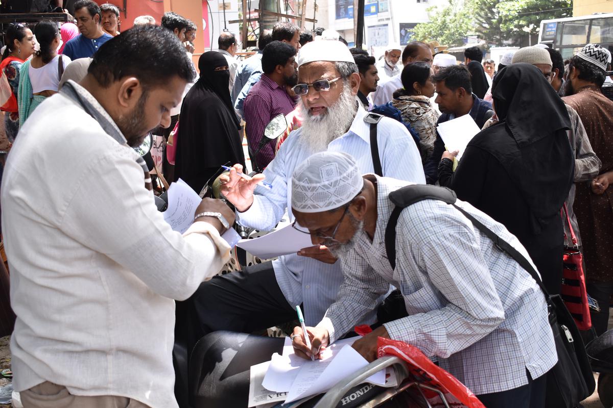 Investors filling in details of their deposits before submitting them to the Commercial Street police station in Bengaluru in June 2019.