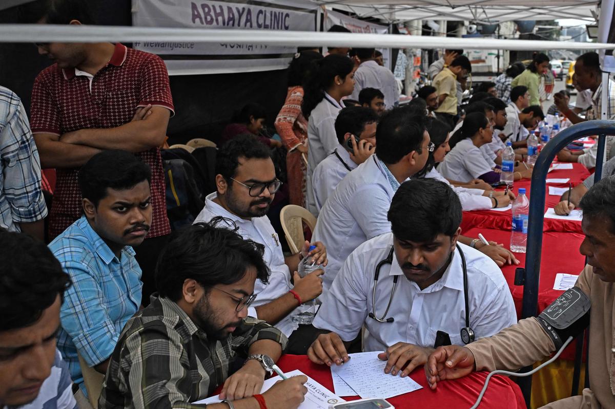 Medical residents attend to patients and distribute free medicines at Abhaya Clinic, a makeshift medical camp along a road in Kolkata, on September 1, 2024. 