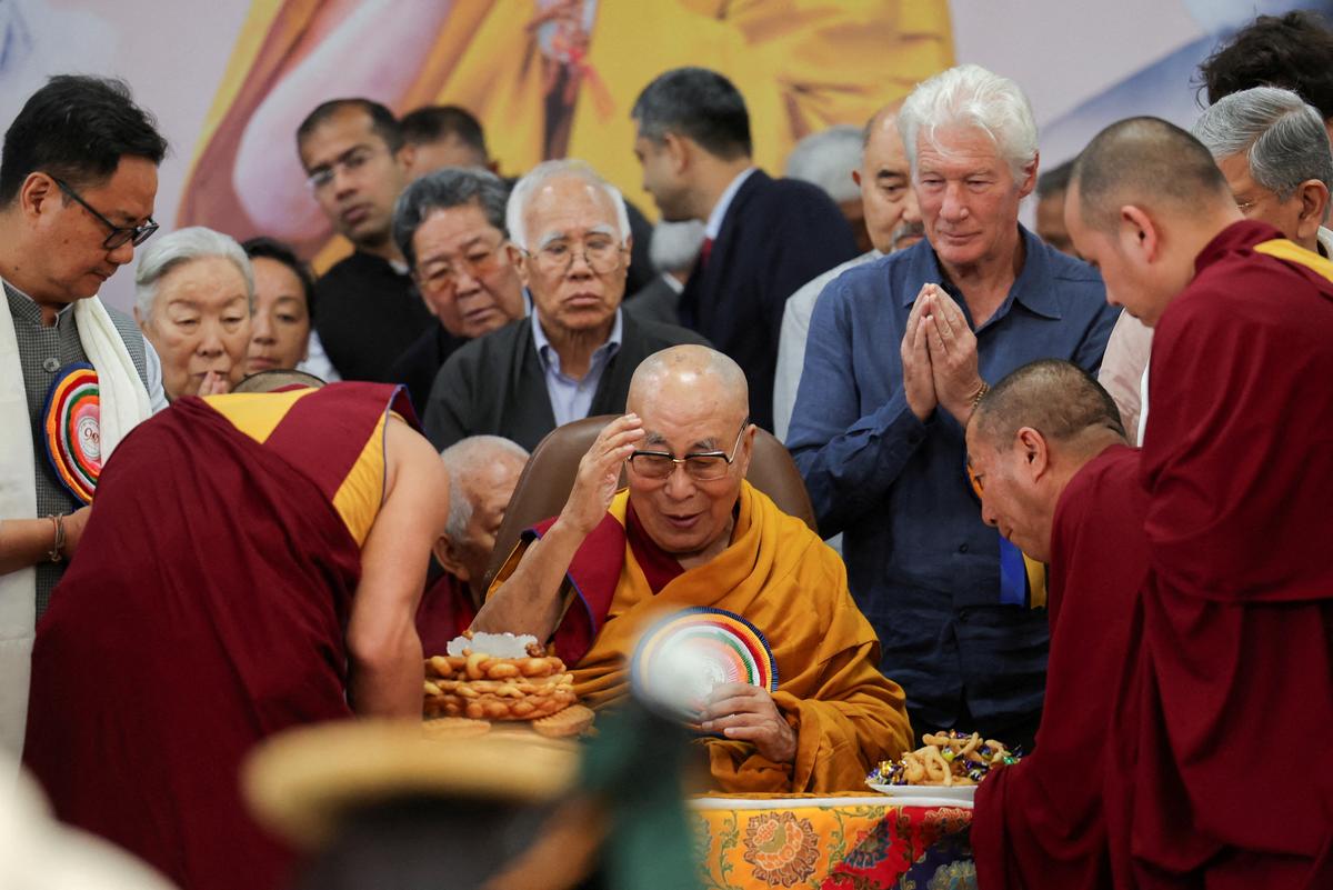 The 14th Dalai Lama, surrounded by visitors and devotees, including Hollywood actor Richard Gere (right) and India’s Minister of Parliamentary Affairs Kiren Rijiju (far left) during his 90th birthday celebrations in Dharamshala.