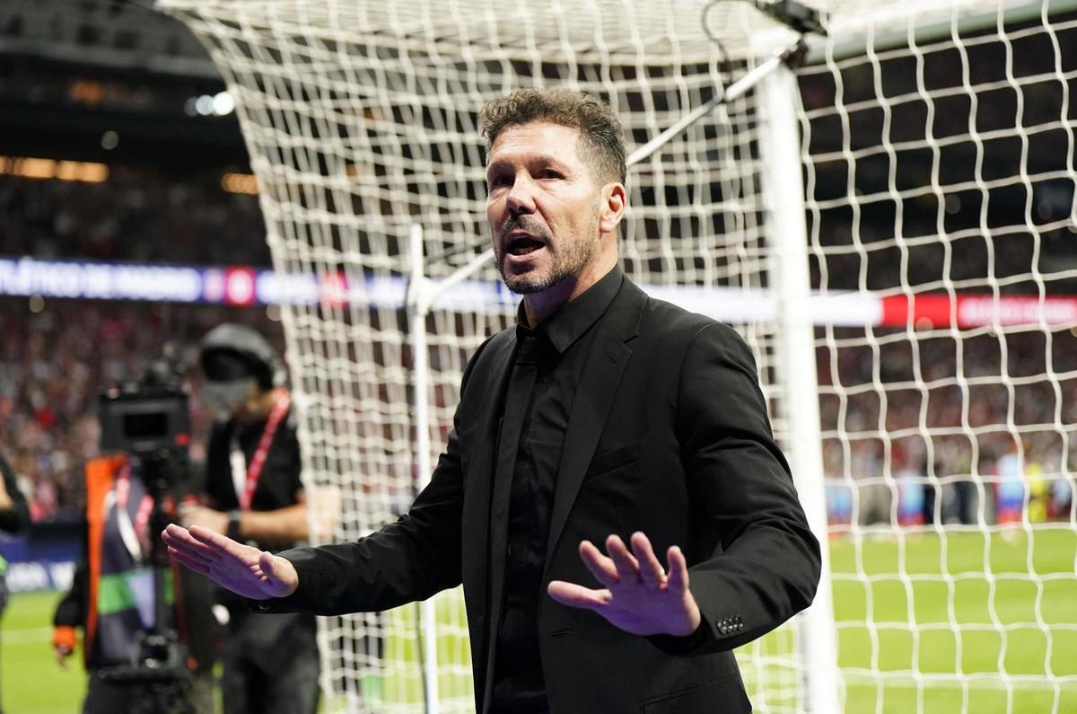 Atletico Madrid coach Diego Simeone talks to the Atletico Madrid fans as play is stopped due to crowd trouble 