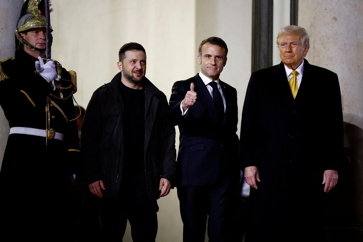 French President Emmanuel Macron accompanies U.S. President-elect Donald Trump and Ukraine’s President Volodymyr Zelenskiy as they leave after a trilateral meeting at the Elysee Palace in Paris as part of ceremonies to mark the reopening of the Notre-Dame de Paris Cathedral, five-and-a-half years after a fire ravaged the Gothic masterpiece, in Paris, France, December 7, 2024. 