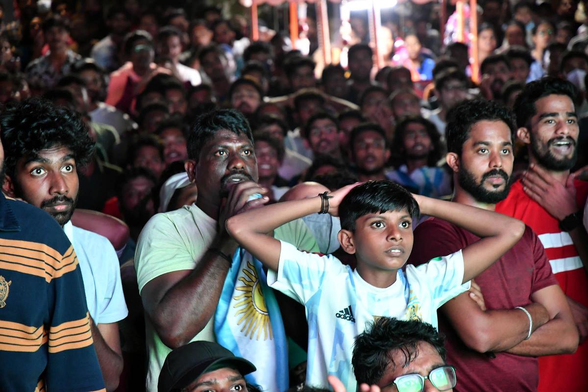 Anxious fans watching the 2022 FIFA World Cup final on a wide screen put up at Shankumugham Beach in Kerala’s Thiruvananthapuram, December 19, 2022.. Anxious fans watching the 2022 FIFA World Cup final on a wide screen put up at Shankumugham Beach in Kerala’s Thiruvananthapuram, December 19, 2022..