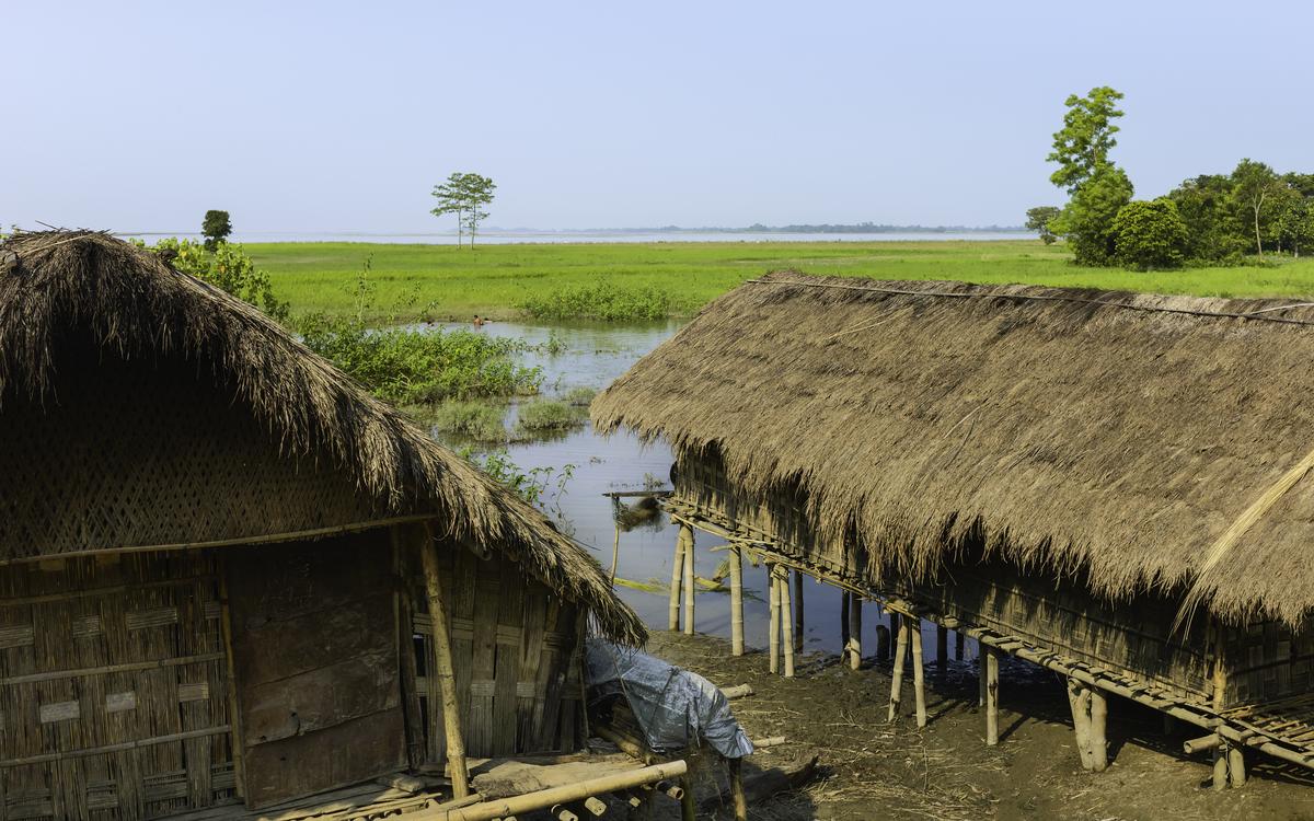 Traditional bamboo houses on stilts, along the Brahmaputra in Assam.