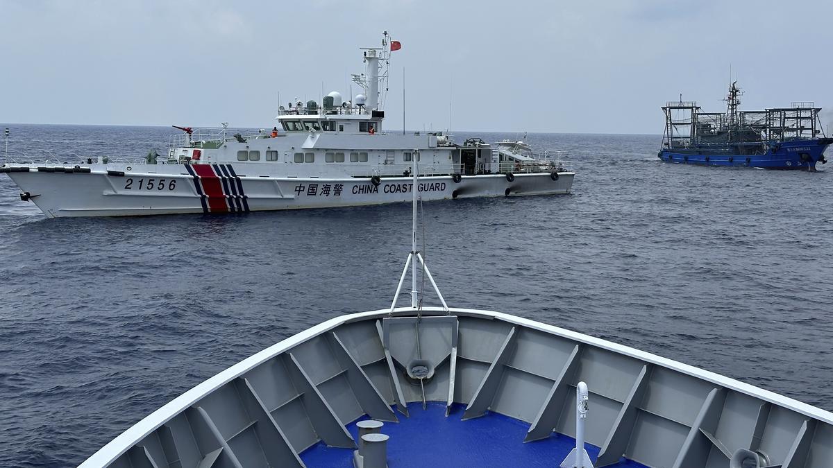 Philippines says a coast guard ship and a supply boat are hit by Chinese vessels near disputed shoal in South China Sea