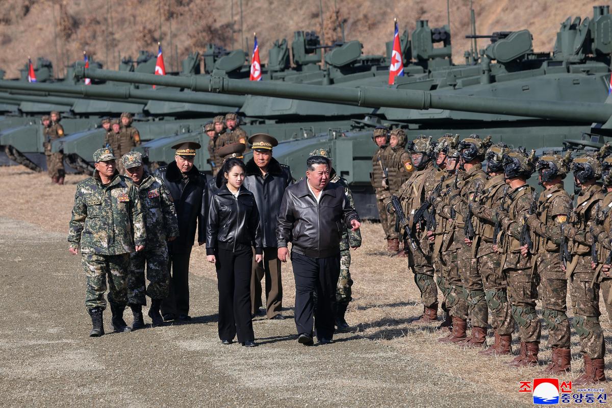 Kim Jong Un, center, and his daughter, reportedly named Kim Ju Ae, visit a military training base in North Korea