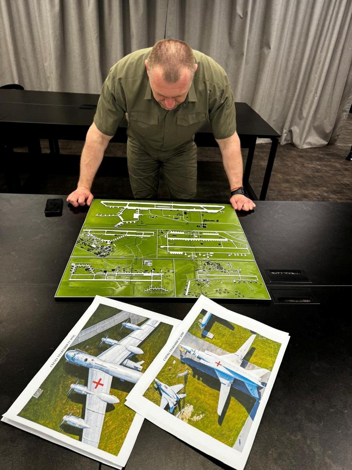 Head of the Ukraine’s Security Service Vasyl Maliuk looks at a map of an airfield, amid Russia’s attack on Ukraine, in an unknown location in Ukraine, in this handout picture released June 1, 2025