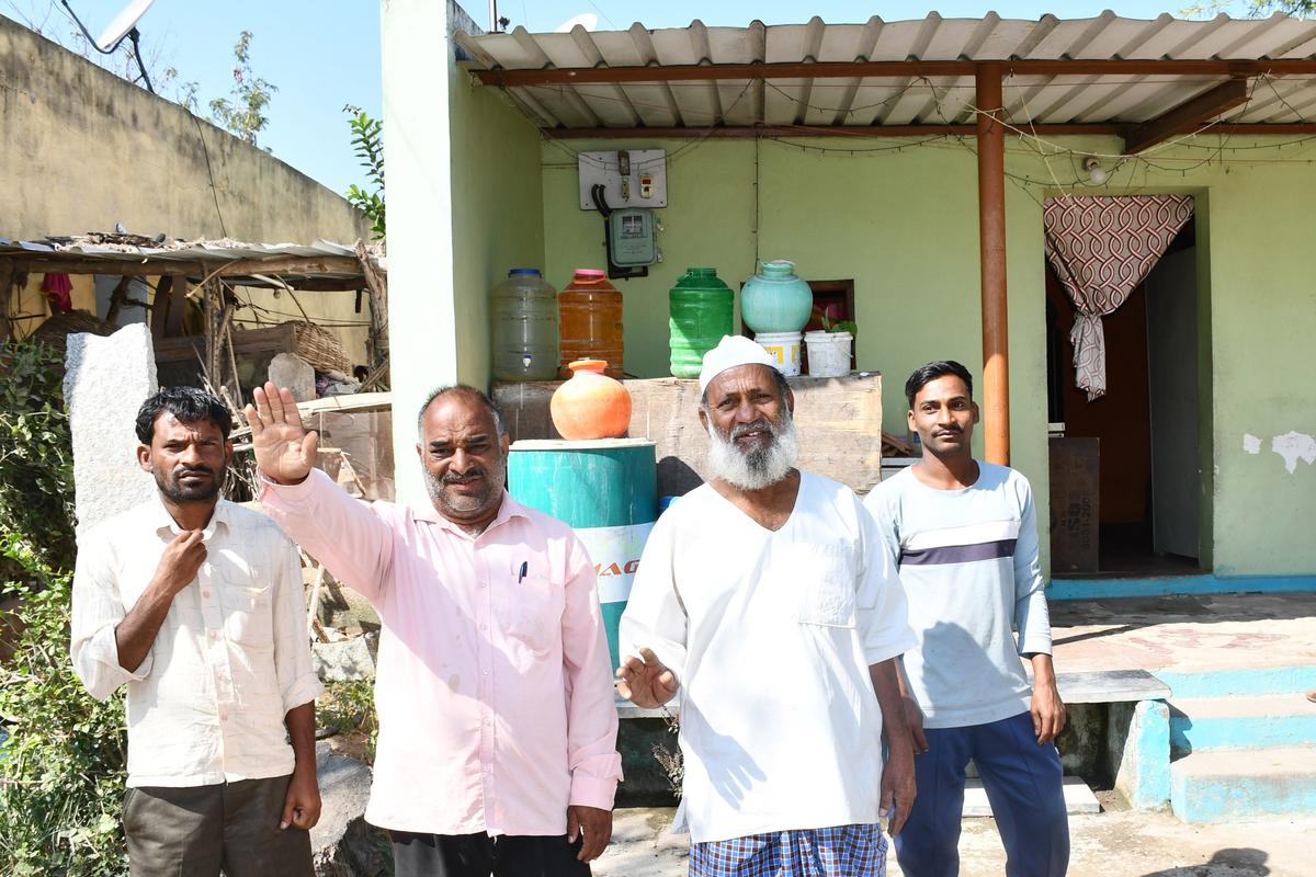 Siblings Noor Ahmed Mujawar and Abdul Razak Mujawar narrating the legend of Hazrat Dawal Malik standing before the house that has just a curtain as its door in their hamlet Dawal Malik. 