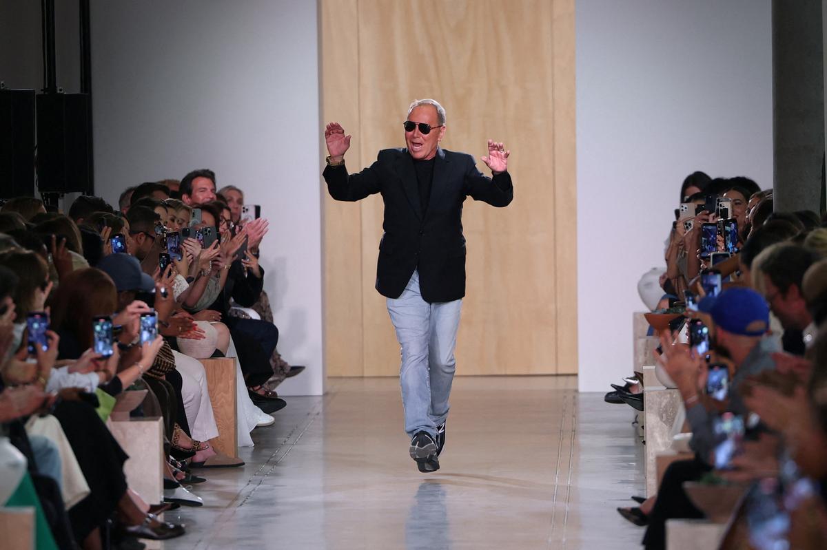 Designer Michael Kors appears on the runway at the conclusion of the presentation of his Spring 2026 collection.