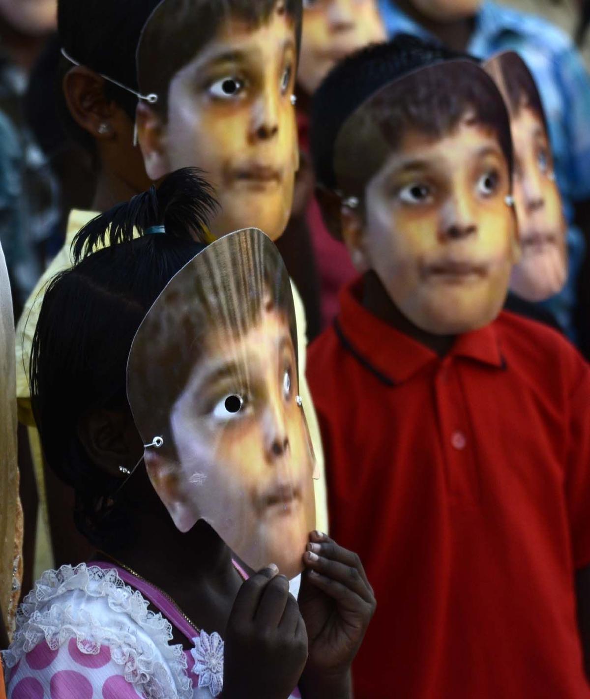 Children wearing the mask of Balachandran, Prabhakaran’s son, at a rally in Chennai, protesting his death. 