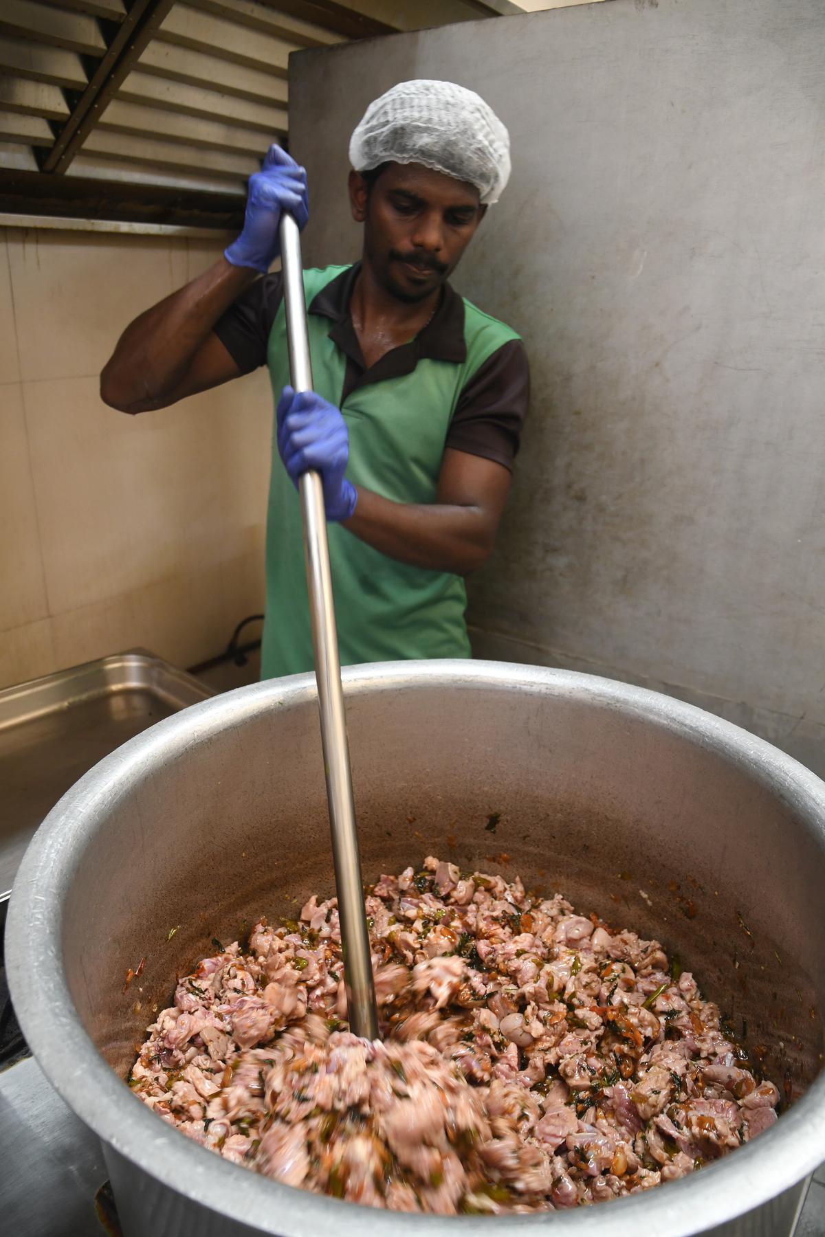 Dindigul biryani in the making in a gigantic ‘vatta‘ made of aluminum for uniform heat distribution at Ponram. 