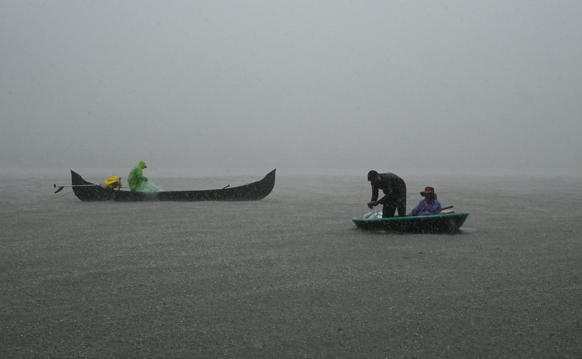 Traditional fishermen engaged in fishing in the Kochi backwaters during heavy rain on Friday. The State government banned fishing within a 20-nautical-mile radius of the capsized Liberian-flagged container ship that sank off the Kerala coast on May 25 as a precautionary measure.