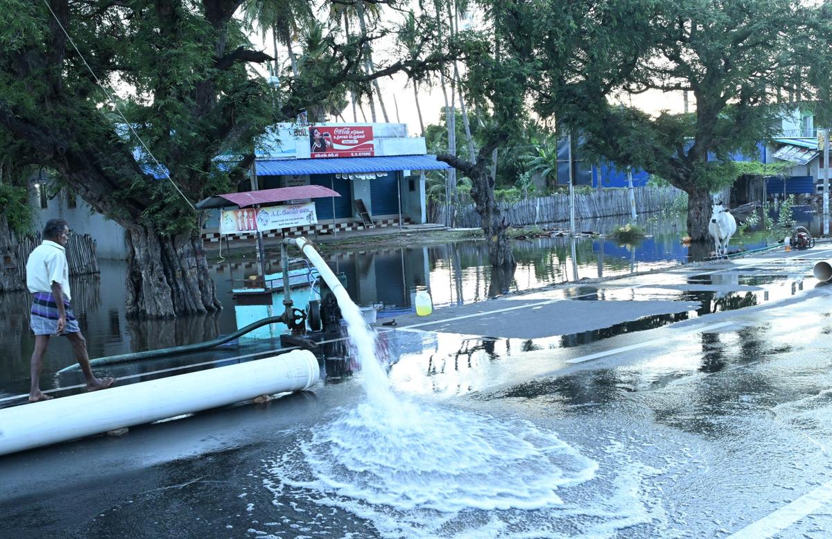 Rainwater being pumped out of  house at Vedhalam near Mandapam on Wednesday.